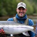 Experienced angler David S. proudly holding a large salmon.